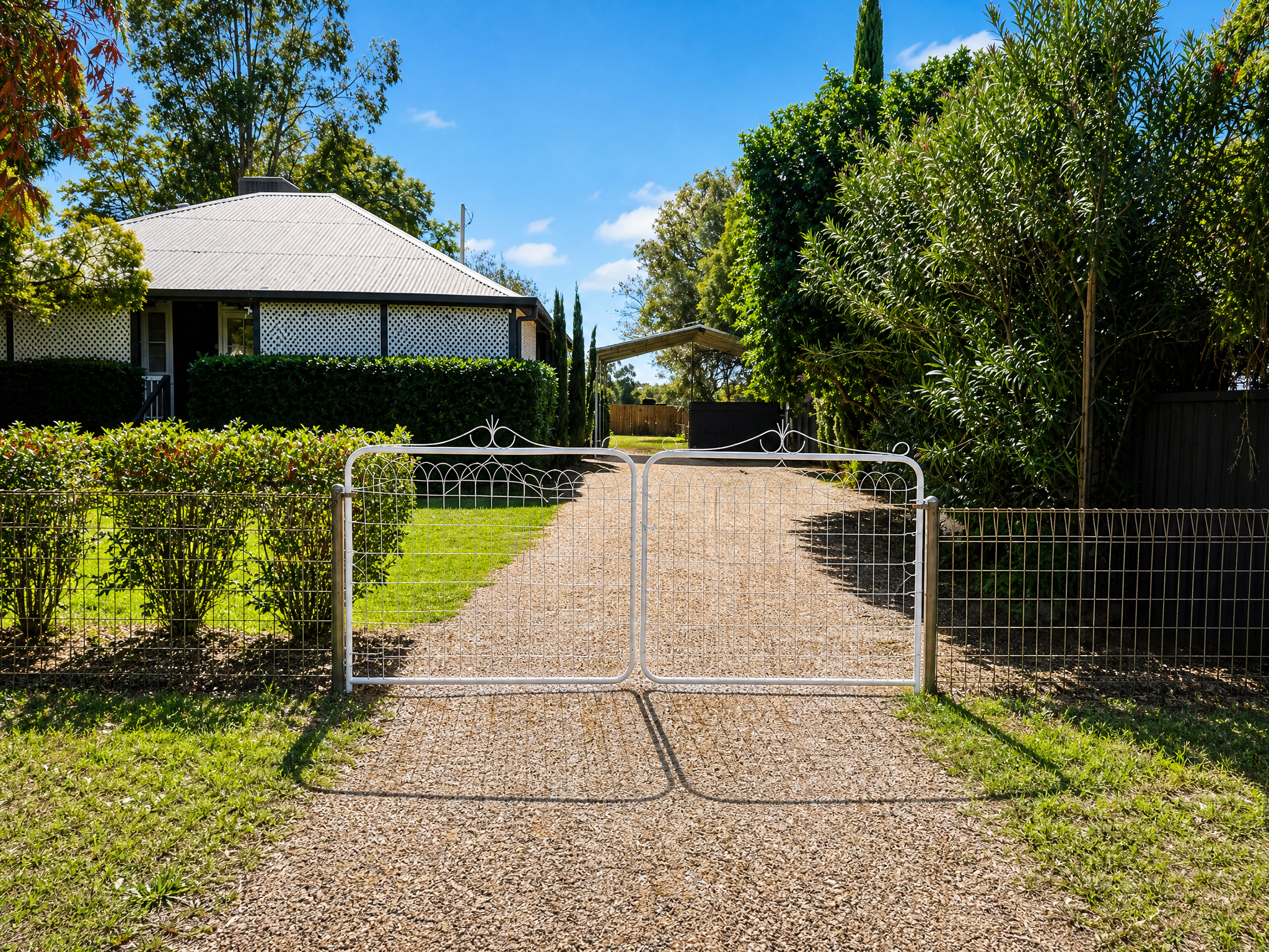 White wire gates and gravel driveway at Little Anchorage, St George